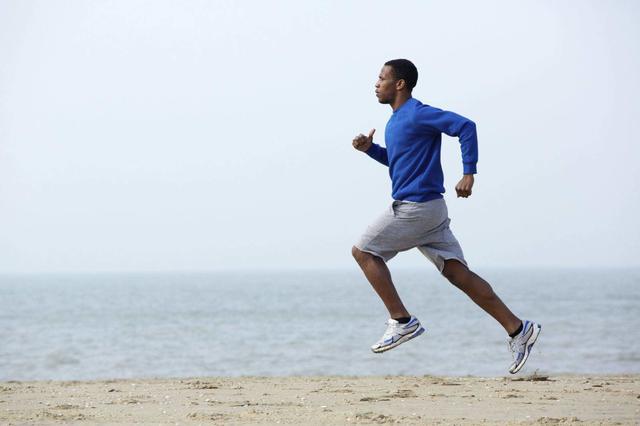 black-man-running-on-beach-exercise-fitness.jpg